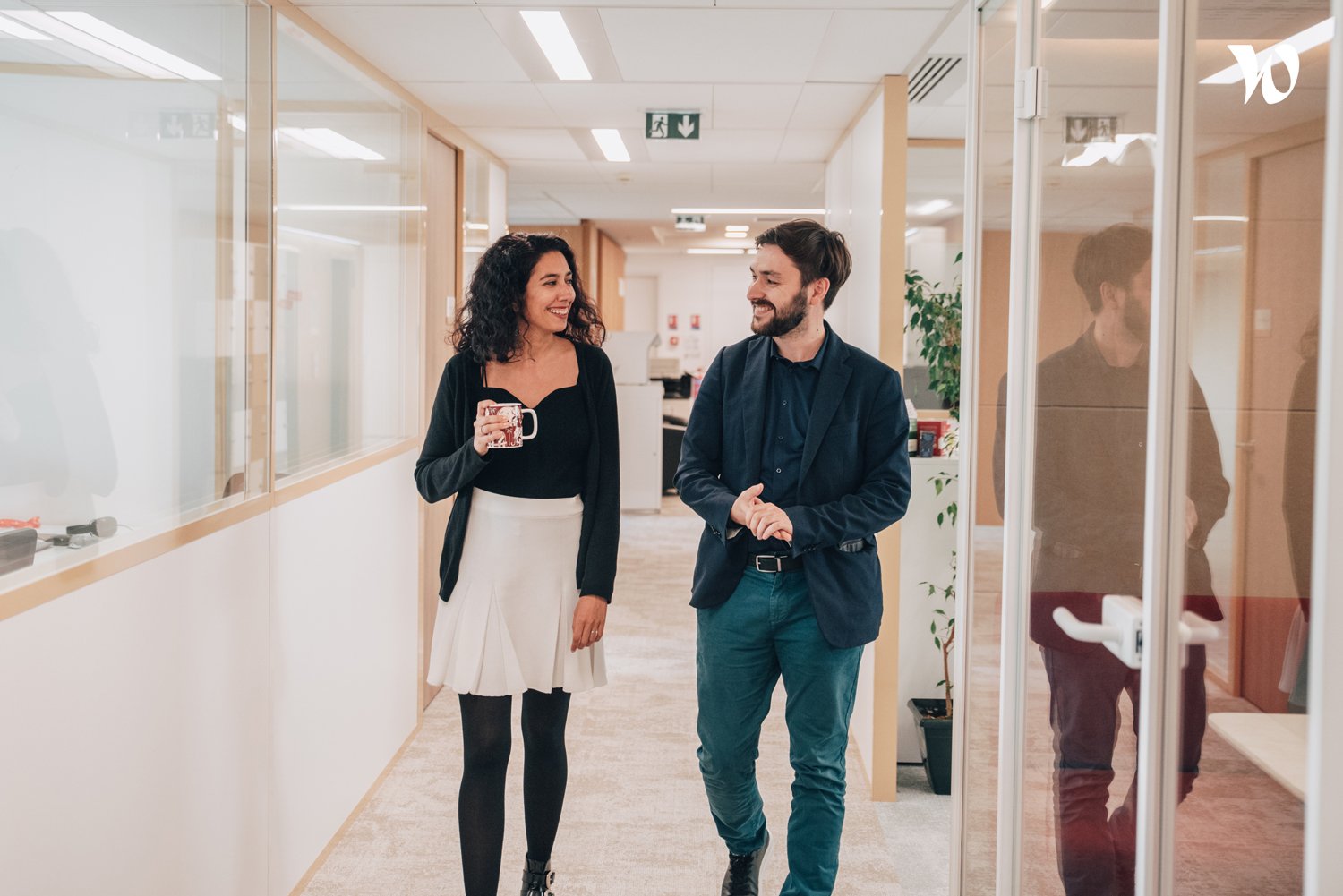 Deux collaborateurs TAKOMA déambulent dans un couloir en pleine discussion